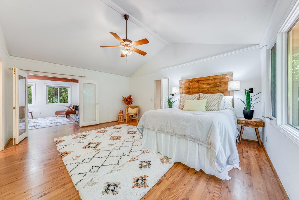 168 Riverside Drive Boulder Creek, CA 95006 - Photo 21 of 52 a bedroom with a bed and wooden floor