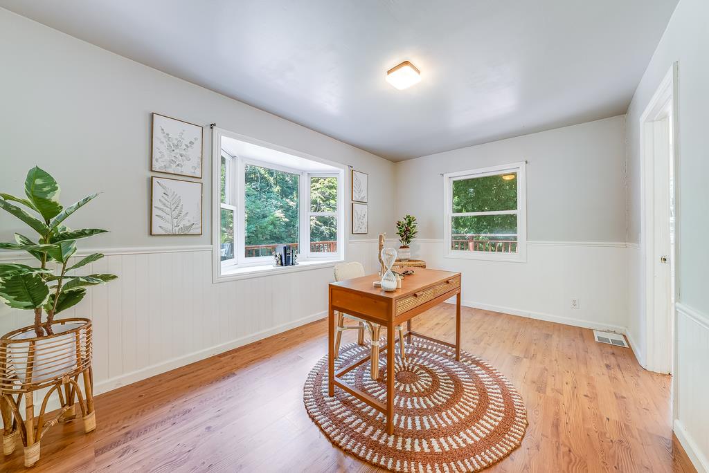 168 Riverside Drive Boulder Creek, CA 95006 - Photo 25 of 52 a dining room with furniture a rug and a potted plant