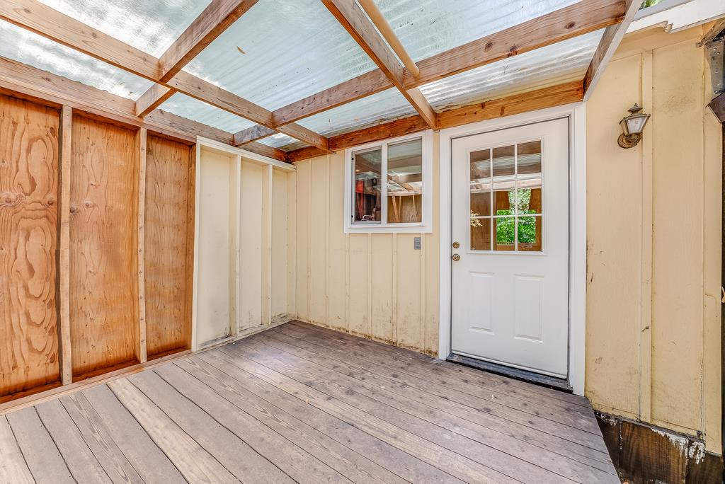 168 Riverside Drive Boulder Creek, CA 95006 - Photo 28 of 52 a view of an empty room with wooden floor and a window