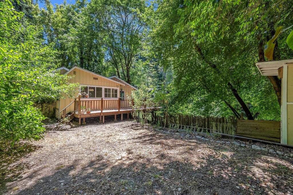 168 Riverside Drive Boulder Creek, CA 95006 - Photo 44 of 52 a house with tall trees in the background