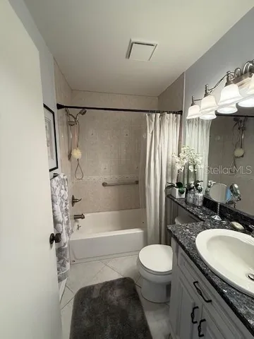 a bathroom with a sink toilet a shower and a mirror