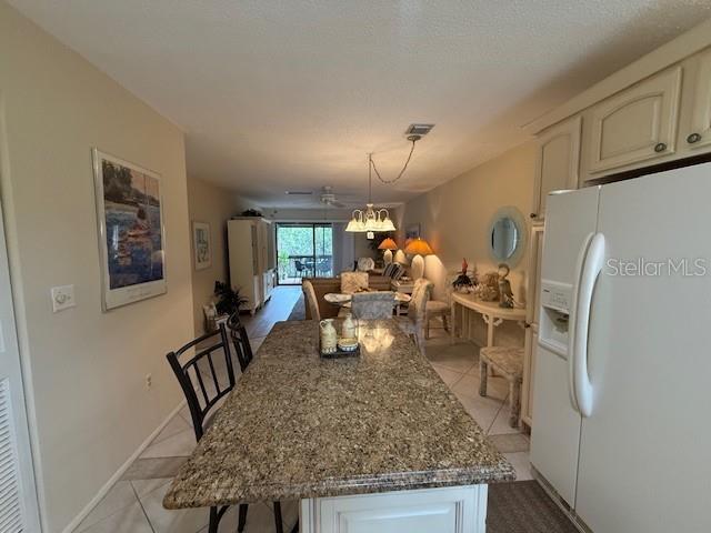 1648 Stickney Point Road, Unit 48202 Sarasota, FL 34231 - Photo 18 of 18 a living room with furniture and a table