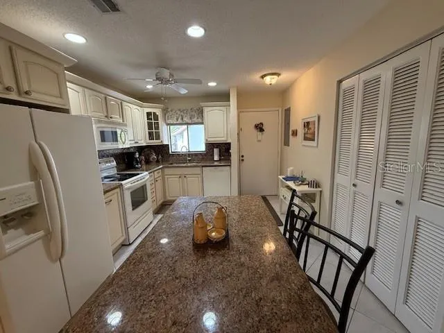a kitchen with stainless steel appliances a refrigerator and a stove top oven
