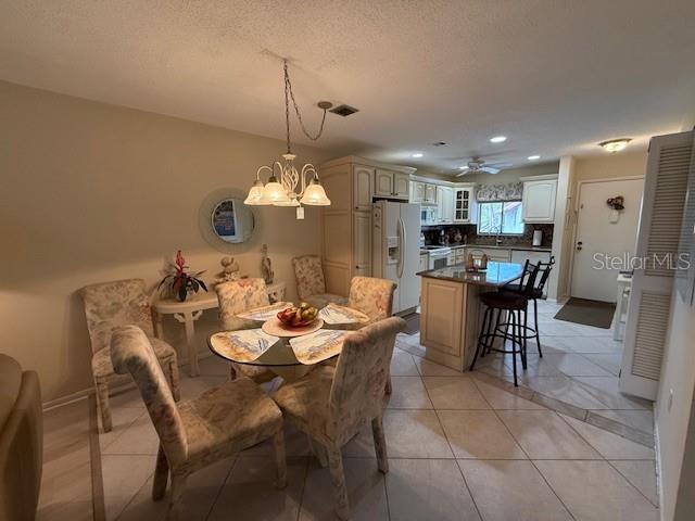 1648 Stickney Point Road, Unit 48202 Sarasota, FL 34231 - Photo 5 of 18 a view of a dining room and livingroom with furniture wooden floor a chandelier