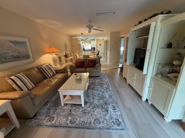 1648 Stickney Point Road, Unit 48202 Sarasota, FL 34231 - Photo 6 of 18 a living room with furniture and a rug