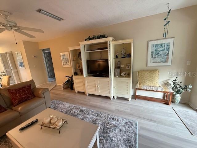 1648 Stickney Point Road, Unit 48202 Sarasota, FL 34231 - Photo 7 of 18 a living room with furniture and a flat screen tv