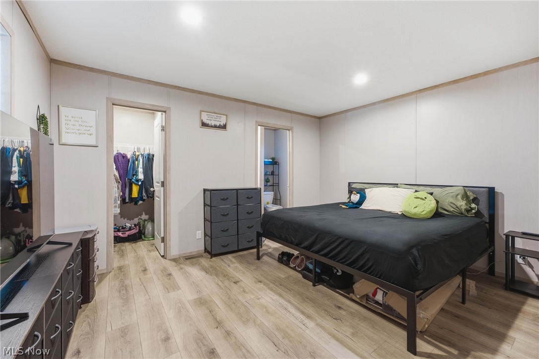 4516 Navarre Road Southwest, Unit 13 Canton, OH 44706 - Photo 12 of 30 Wood-finish flooring throughout, recessed ceiling lighting, and a walk-in closet with built-in shelving