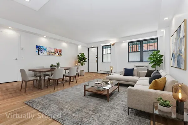 a living room with furniture potted plant and a table