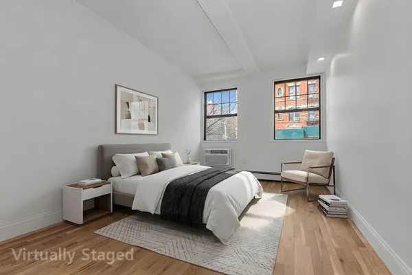 a bedroom with a bed and a couch