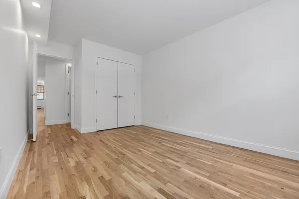 a view of an empty room and wooden floor