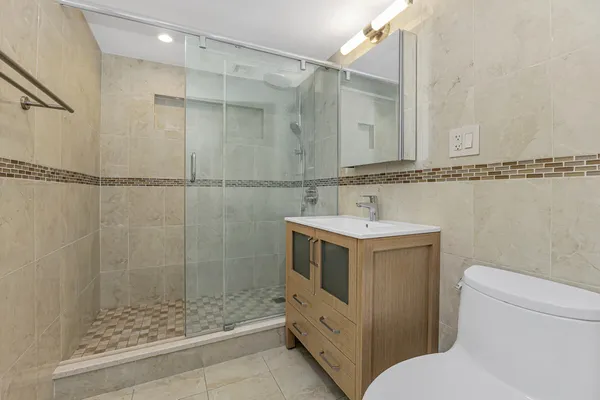a bathroom with a sink toilet and shower