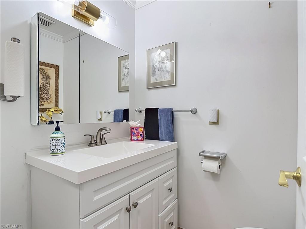 2280 Capri Court Naples, FL 34105 - Photo 18 of 49 a bathroom with a sink and a mirror