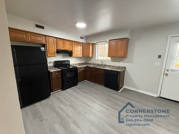 a kitchen with stainless steel appliances granite countertop a refrigerator a sink a stove and island