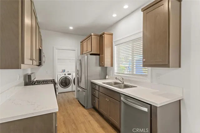 a kitchen with a refrigerator sink and cabinets