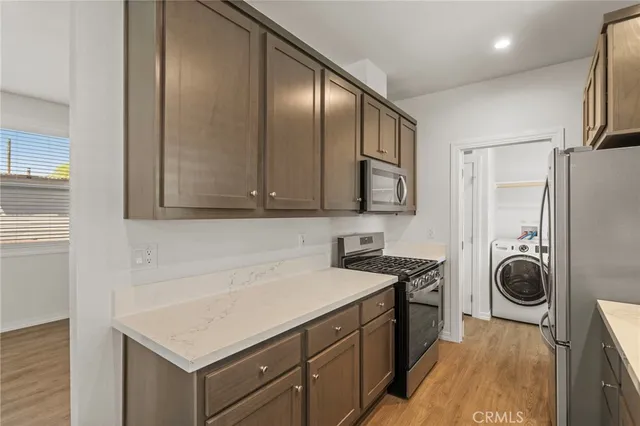 a bathroom with a sink a toilet a mirror and shower