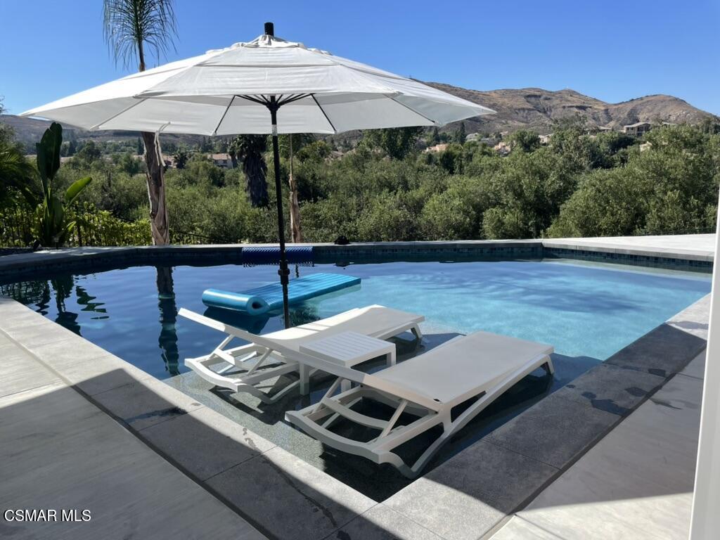 575 Fairfield Road Simi Valley, CA 93065 - Photo 6 of 57 a view of a terrace with furniture and an umbrella