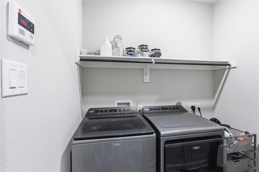 1012 Calhoun Drive Anna, TX 75409 - Photo 28 of 39 Dedicated laundry area featuring a built-in white shelf with a hanging rod and white walls