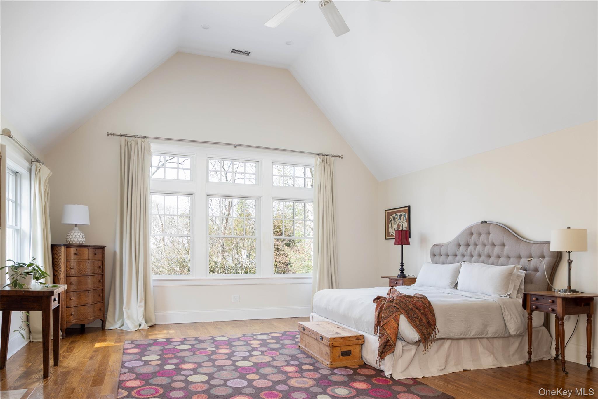 53 Cedar Lane West Remsenburg, NY 11960 - Photo 29 of 38 Bedroom featuring a ceiling fan, wood finished floors, visible vents, high vaulted ceiling, and baseboards