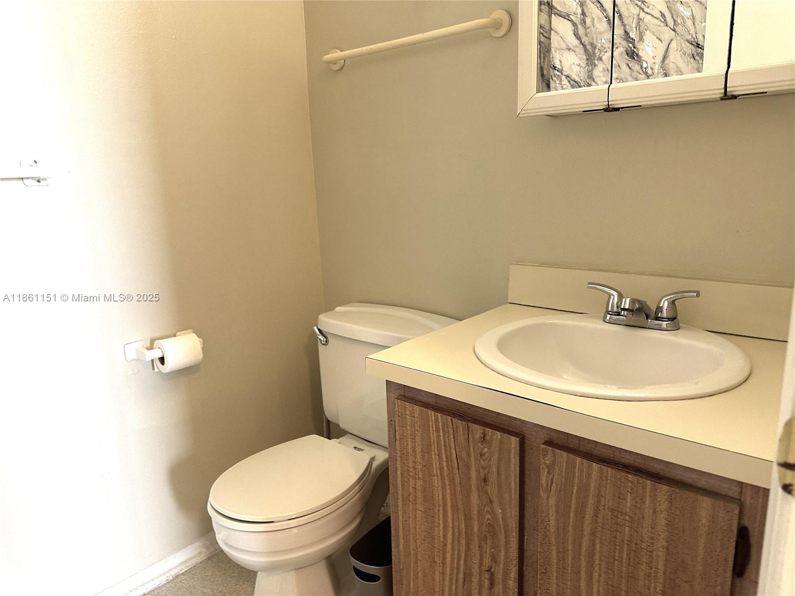 2501 Riverside Drive, Unit 506A Coral Springs, FL 33065 - Photo 12 of 15 a bathroom with a sink and a toilet