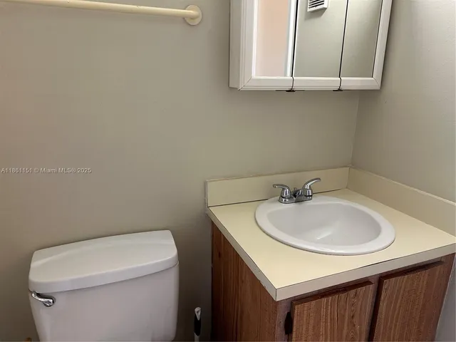 a bathroom with a sink a toilet and mirror