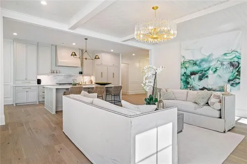 a living room with fireplace furniture and a chandelier