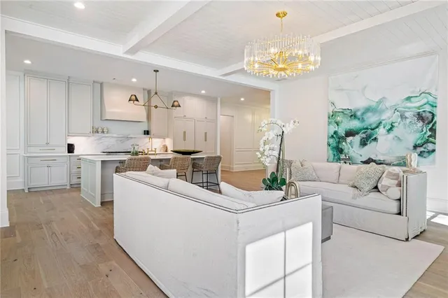 a living room with fireplace furniture and a chandelier