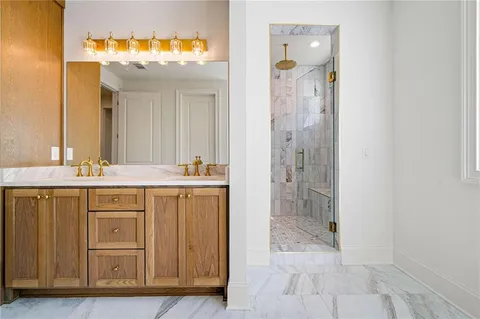 a bathroom with a shower sink and mirror