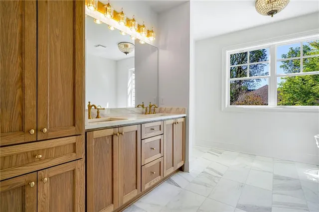 a bathroom with a sink a vanity and a mirror