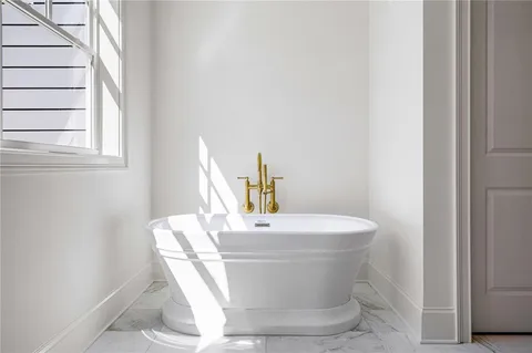 a white bath tub sitting next to a white sink
