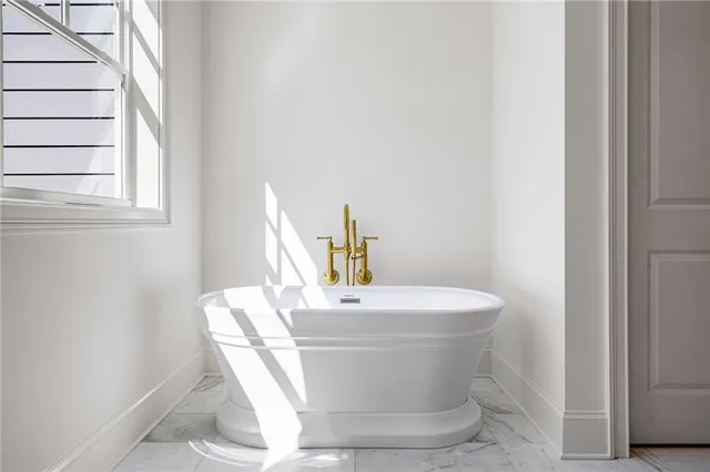 a white bath tub sitting next to a white sink
