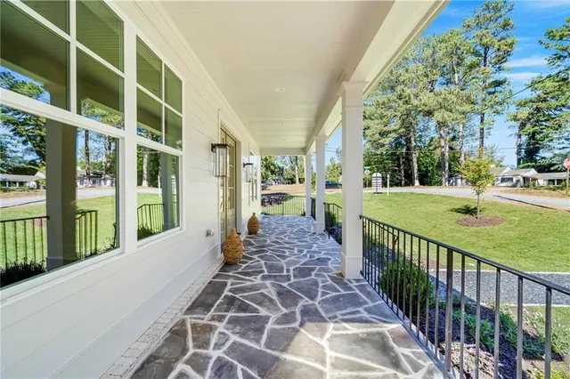 a view of a porch with wooden floor and fence
