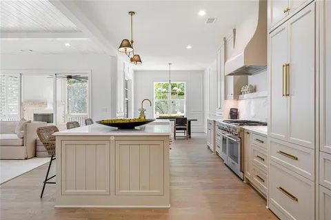 a kitchen with stainless steel appliances granite countertop a stove a sink and a refrigerator