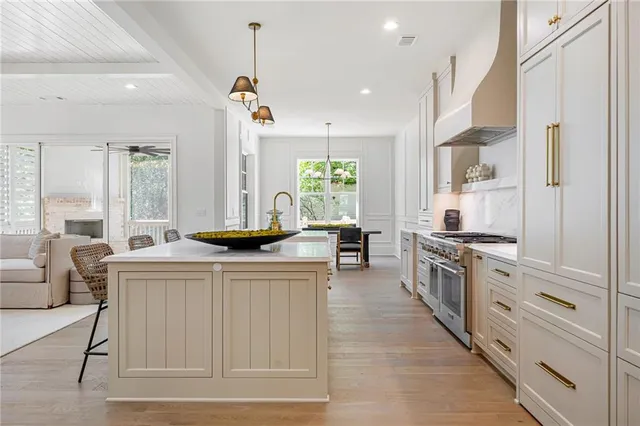 a kitchen with stainless steel appliances granite countertop a stove a sink and a refrigerator