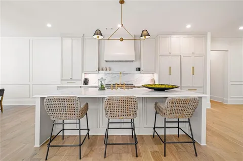 a kitchen with a table chairs and cabinets