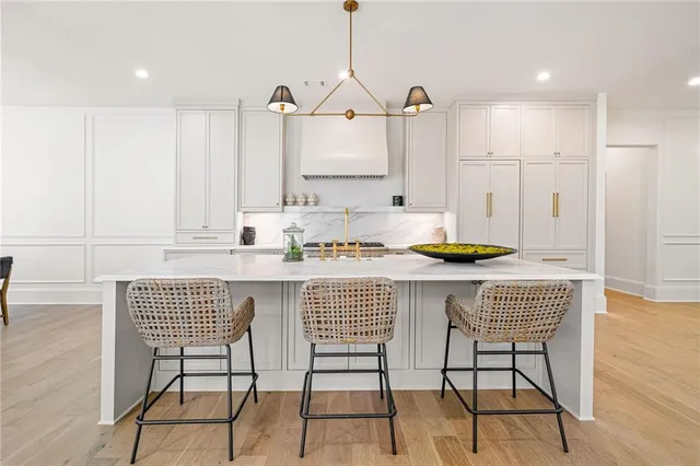 a kitchen with a table chairs and cabinets