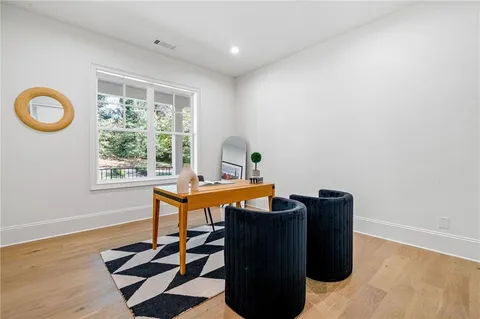 a view of a workspace with furniture and a window
