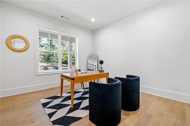 a view of a workspace with furniture and a window