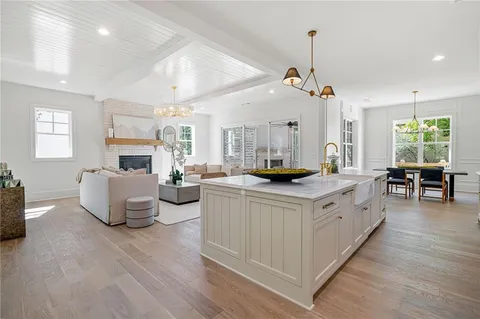 a kitchen with living room and white cabinets
