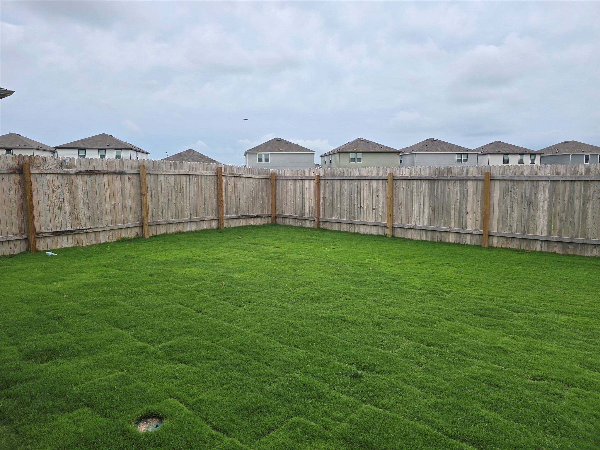 509 McFadin Way Taylor, TX 76574 - Photo 20 of 23 a view of a green field with wooden fence