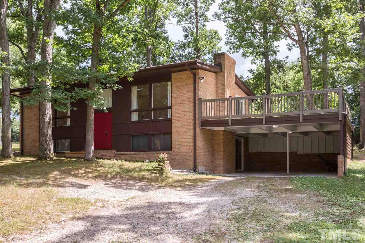 3900 Donna Road Raleigh, NC 27604 - Photo 2 of 25 a front view of a house with a yard and garage