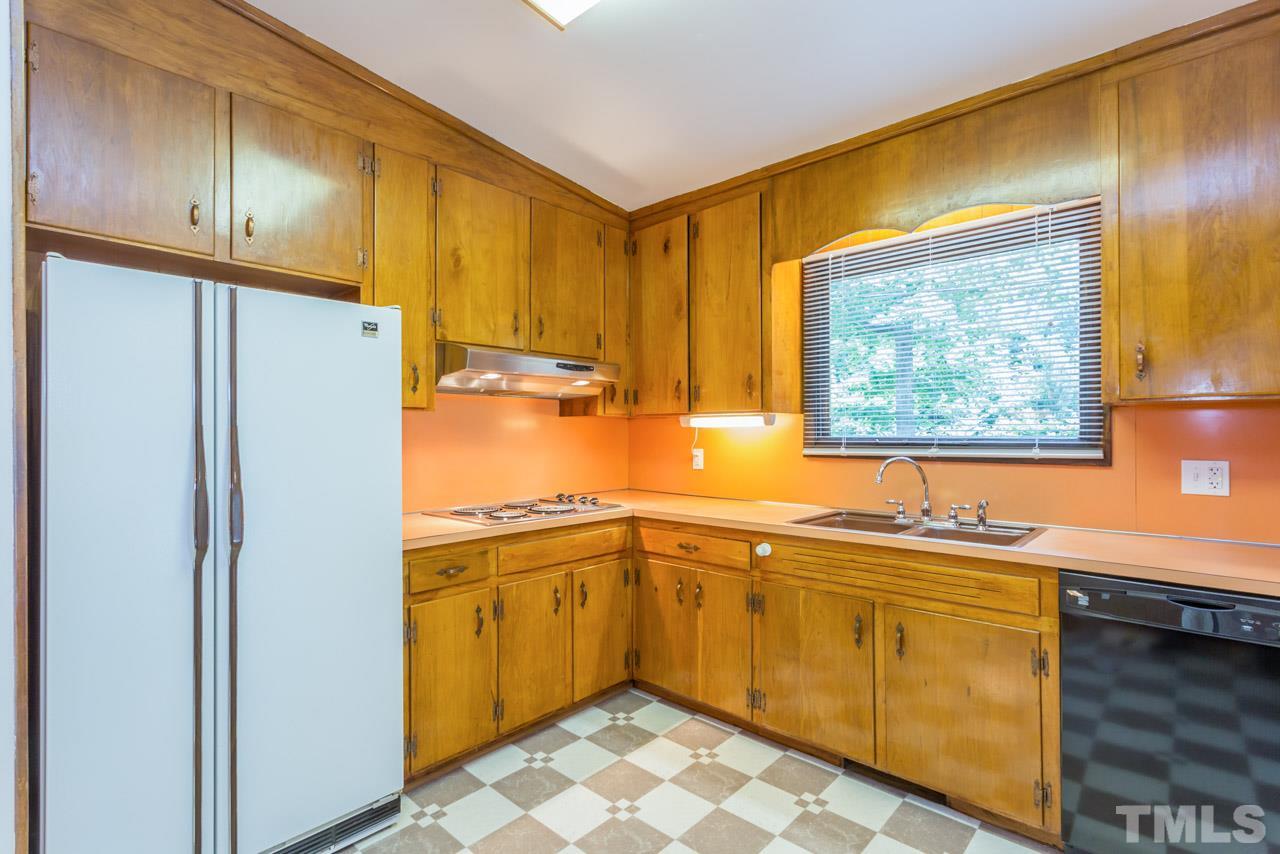 3900 Donna Road Raleigh, NC 27604 - Photo 13 of 25 a kitchen with a sink refrigerator and cabinets