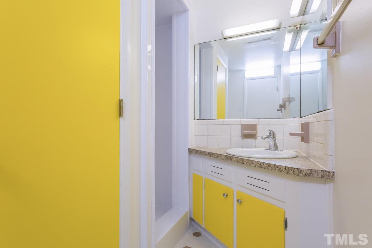 3900 Donna Road Raleigh, NC 27604 - Photo 16 of 25 a bathroom with a granite countertop sink and a mirror