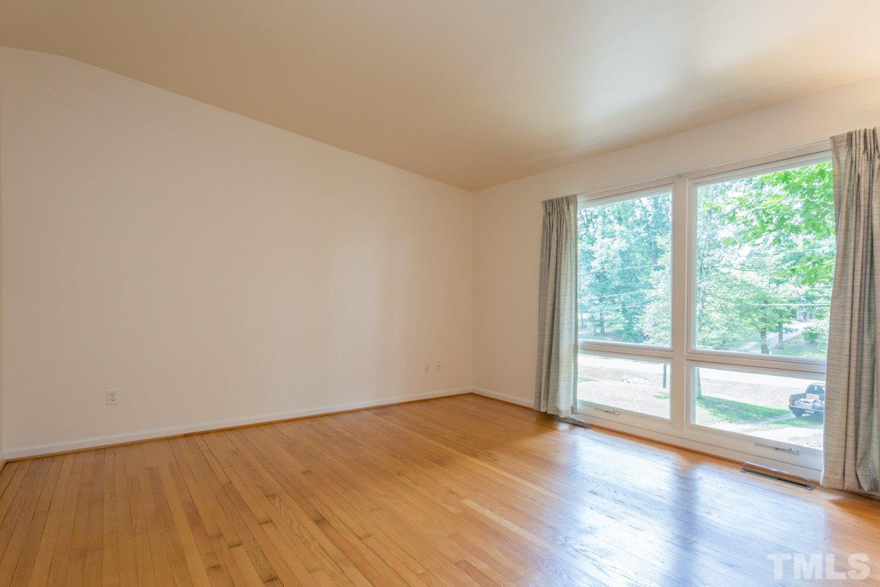 3900 Donna Road Raleigh, NC 27604 - Photo 5 of 25 a view of an empty room with wooden floor and a window