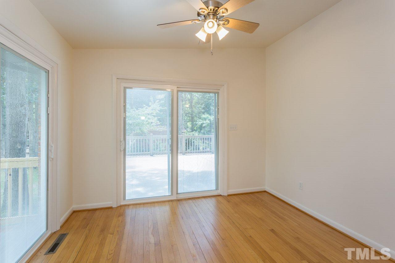 3900 Donna Road Raleigh, NC 27604 - Photo 6 of 25 a view of an empty room with wooden floor and a window