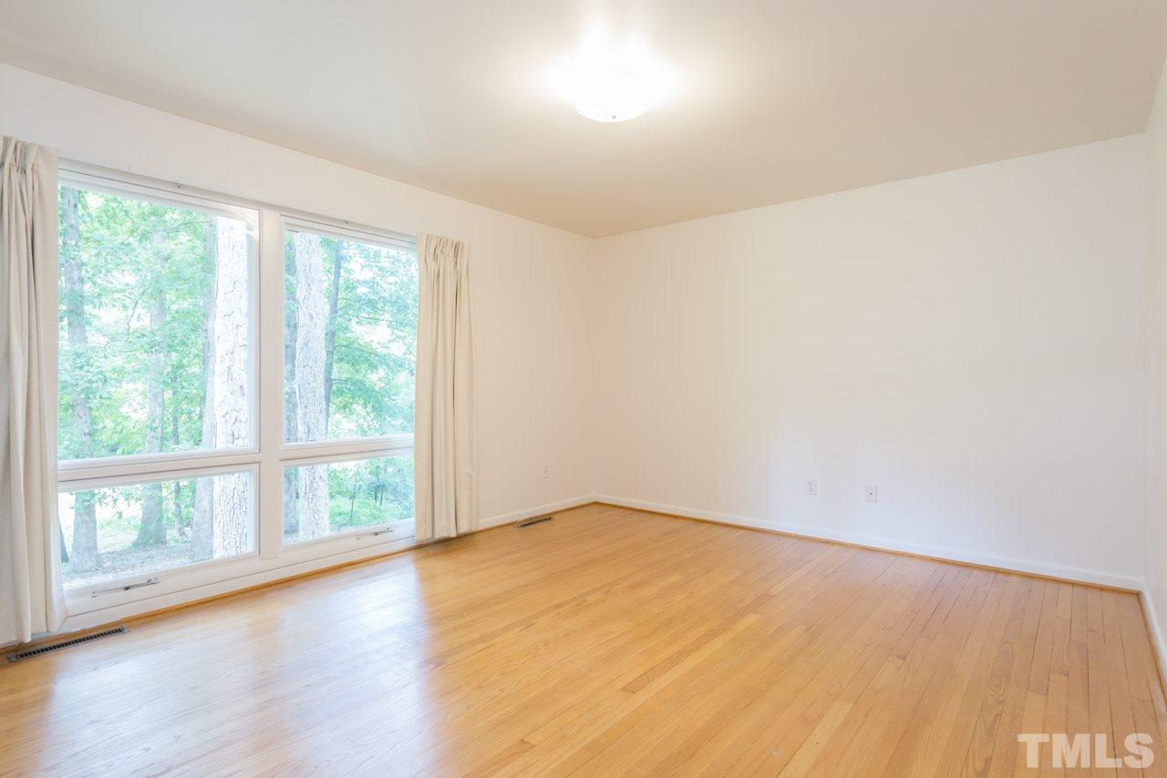 3900 Donna Road Raleigh, NC 27604 - Photo 7 of 25 an empty room with wooden floor and windows