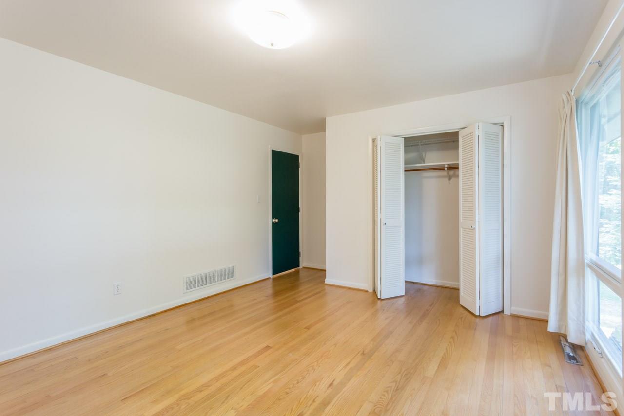 3900 Donna Road Raleigh, NC 27604 - Photo 8 of 25 an empty room with wooden floor and windows