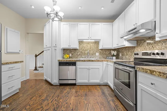a kitchen with a white cabinets stove and refrigerator