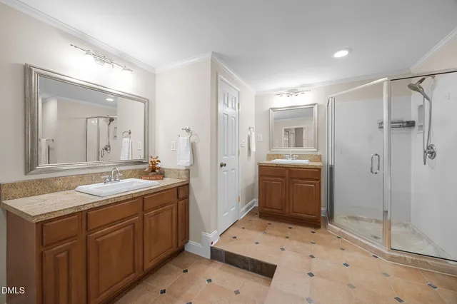 a spacious bathroom with a shower sink and mirror