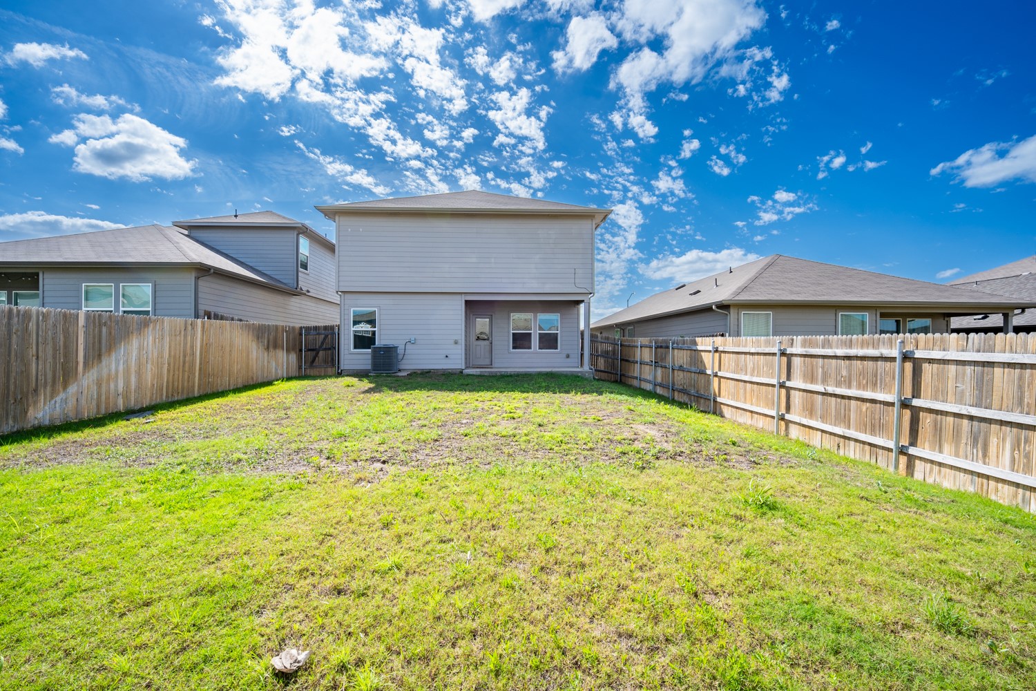 14917 Bajada Rd Manor Manor, TX 78653 - Photo 28 of 31 Expansive backyard with a sloped lawn and full privacy fencing