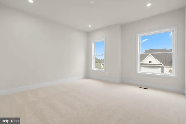 an empty room with windows and closet